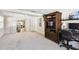 Spacious living room with neutral carpet, television, and access to dining area at 4610 W Mcelroy Ave, Tampa, FL 33611