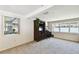 Neutral living room with television and windows offering serene views of the neighborhood at 4610 W Mcelroy Ave, Tampa, FL 33611