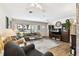 Bright and open living room boasting hardwood floors, a large window, and stylish decor at 4610 W Mcelroy Ave, Tampa, FL 33611