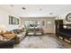 Spacious living room with hardwood floors, large window, and comfortable seating arrangements at 4610 W Mcelroy Ave, Tampa, FL 33611