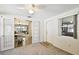 Cozy living room with neutral carpet, open access to dining room and natural light at 4610 W Mcelroy Ave, Tampa, FL 33611