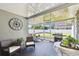 Enclosed patio featuring comfortable seating, a grill, and views of the backyard at 4610 W Mcelroy Ave, Tampa, FL 33611