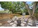 Backyard area featuring a deck, gravel patio, seating around a fire pit, and storage shed at 4803 Highland, Tampa, FL 33603
