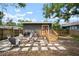 Backyard featuring a fire pit with chairs, a patio, and wooden fence around the property at 4803 Highland, Tampa, FL 33603