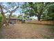 Expansive backyard with mature trees, outdoor seating area, and secure fence, offering a serene retreat at 4803 Highland, Tampa, FL 33603