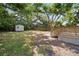 Large, shady backyard features a shed, wooden deck, and fenced perimeter for privacy and security at 4803 Highland, Tampa, FL 33603