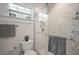 Elegant bathroom featuring marble-tiled shower, sleek glass door, and modern fixtures at 4803 Highland, Tampa, FL 33603