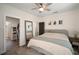 Comfortable bedroom with a ceiling fan, natural light, wood floors, and a view into the walk-in closet and bathroom at 4803 Highland, Tampa, FL 33603
