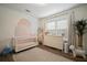 Bright Bedroom with white crib, dresser, neutral rug, and a decorative mural at 4803 Highland, Tampa, FL 33603