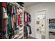Spacious walk-in closet with custom shelving, rods, and an adjacent view into the bathroom area at 4803 Highland, Tampa, FL 33603