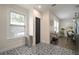 Entry area featuring decorative black-and-white tiled floors, a window, and a beverage cart at 4803 Highland, Tampa, FL 33603