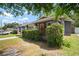 Charming bungalow featuring a cozy front porch, brick pillars and lush green hedge at 4803 Highland, Tampa, FL 33603