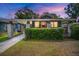 Charming bungalow featuring a cozy front porch, brick pillars and lush green hedge at 4803 Highland, Tampa, FL 33603