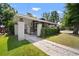 Charming bungalow featuring a cozy front porch, brick pillars and lush green hedge at 4803 Highland, Tampa, FL 33603