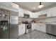 Modern kitchen features stainless steel appliances, white cabinetry, and unique backsplash and floors at 4803 Highland, Tampa, FL 33603