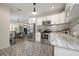 Well-lit kitchen with white cabinets and stainless steel appliances leads into dining and living area at 4803 Highland, Tampa, FL 33603