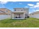 Spacious backyard with a covered patio, ideal for outdoor activities and relaxation at 5068 Little Stream Ln, Wesley Chapel, FL 33545