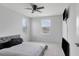 Bright bedroom featuring neutral walls, plush carpet, and natural light streaming through two windows at 5068 Little Stream Ln, Wesley Chapel, FL 33545
