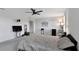 Bright bedroom with a ceiling fan, gray carpet, and plenty of space for entertainment and relaxation at 5068 Little Stream Ln, Wesley Chapel, FL 33545