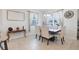 A dining room features neutral colored chairs and a dark wood table at 5068 Little Stream Ln, Wesley Chapel, FL 33545