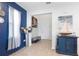 Stylish entryway with blue accent wall, tile flooring, modern decor, and a view into the home at 5068 Little Stream Ln, Wesley Chapel, FL 33545