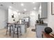 A full kitchen view shows pendant lighting, a granite island, and stainless appliances at 5068 Little Stream Ln, Wesley Chapel, FL 33545