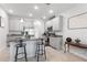 Open kitchen with granite island, pendant lights, stainless appliances, and breakfast bar at 5068 Little Stream Ln, Wesley Chapel, FL 33545