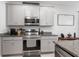 The kitchen has modern stainless steel appliances and grey cabinetry at 5068 Little Stream Ln, Wesley Chapel, FL 33545