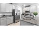 Modern kitchen with gray cabinets, granite countertops, stainless steel appliances, and ample storage at 5068 Little Stream Ln, Wesley Chapel, FL 33545