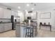 Stylish kitchen featuring granite countertops, stainless appliances, an island with seating, and gray cabinetry at 5068 Little Stream Ln, Wesley Chapel, FL 33545