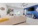 Comfortable living room featuring tile floors, modern entertainment center, and access to the outdoor space at 5068 Little Stream Ln, Wesley Chapel, FL 33545