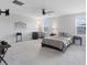 The large primary bedroom features a ceiling fan and windows for natural light at 5068 Little Stream Ln, Wesley Chapel, FL 33545