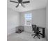 Office featuring a desk, a pet crate, and a window at 5068 Little Stream Ln, Wesley Chapel, FL 33545