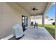 Covered patio with ceiling fan and outdoor seating, perfect for enjoying the outdoors at 5068 Little Stream Ln, Wesley Chapel, FL 33545