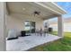 Covered patio featuring a table and chairs at 5068 Little Stream Ln, Wesley Chapel, FL 33545