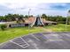 Charming clubhouse features a unique architectural design, surrounded by well-manicured lawns and lush tropical foliage at 5150 Damsen Cir, New Port Richey, FL 34653
