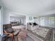 Spacious living room with two sofas, chair, and well-designed open floor plan at 5150 Damsen Cir, New Port Richey, FL 34653