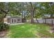 Large backyard featuring a shed, a patio area, green grass and mature trees at 5245 3Rd N Ave, St Petersburg, FL 33710