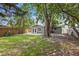 Large backyard featuring a shed, a patio area, green grass and mature trees at 5245 3Rd N Ave, St Petersburg, FL 33710