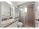 Cozy bathroom with a vanity, sink, toilet, and glass-enclosed shower at 5245 3Rd N Ave, St Petersburg, FL 33710