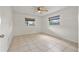 Bright bedroom featuring tile flooring, two windows with blinds, and a ceiling fan at 5245 3Rd N Ave, St Petersburg, FL 33710