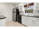 Kitchen with stainless steel appliances, tile backsplash, and built in shelves at 5245 3Rd N Ave, St Petersburg, FL 33710