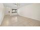 Bright living room featuring neutral tile flooring, ceiling fan, and ample natural light at 5245 3Rd N Ave, St Petersburg, FL 33710