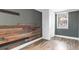 Bedroom features modern wood-look flooring, wood-paneled wall and white closet at 536 Braddock S St, St Petersburg, FL 33707