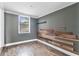 This bedroom features wood floors, a window, and a rustic wood accent wall at 536 Braddock S St, St Petersburg, FL 33707