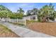 Charming single-story home with a white picket fence and mature palm trees in the front yard at 536 Braddock S St, St Petersburg, FL 33707