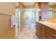 Bathroom with a glass enclosed shower, wood cabinets, and a marble countertop at 5729 Puerta Del Sol S Blvd # 185, St Petersburg, FL 33715