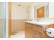 Bright bathroom with a wood vanity, stone countertop, and neutral wall and floor tile at 5729 Puerta Del Sol S Blvd # 185, St Petersburg, FL 33715