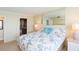 Bright bedroom featuring a Paris themed bedspread, modern lighting, and ensuite bathroom access at 5729 Puerta Del Sol S Blvd # 185, St Petersburg, FL 33715