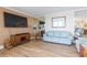 Comfortable living room with light wood floors, modern furniture, and a large screen television at 5729 Puerta Del Sol S Blvd # 185, St Petersburg, FL 33715